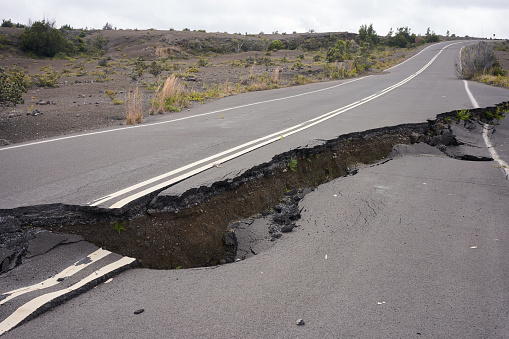 Asphalt road damaged by the volcanic eruption of Kīlauea and caldera collapse with subsequent earthquakes in Hawaii Volcanoes National Park on the Big Island.