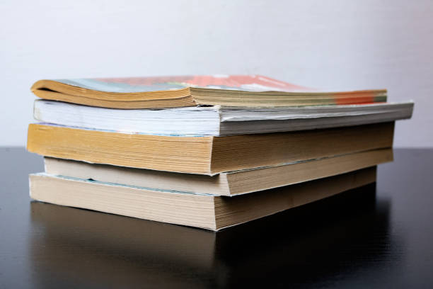 istock Stack of old books on wooden table 1306081774