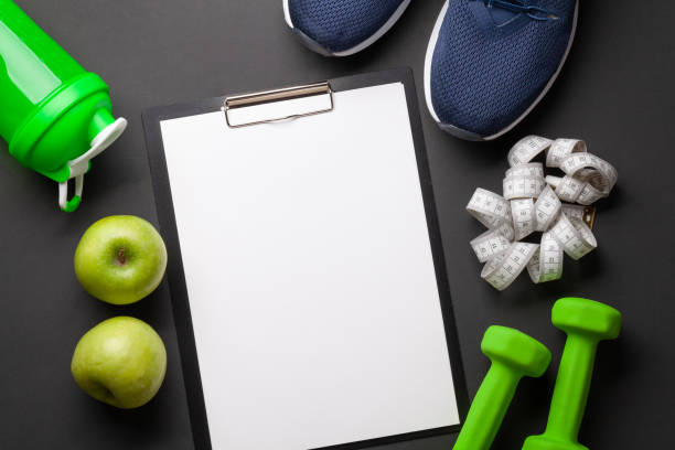 istock Fruits, dumbbells and blank sheet for your plan or goals 1306081775