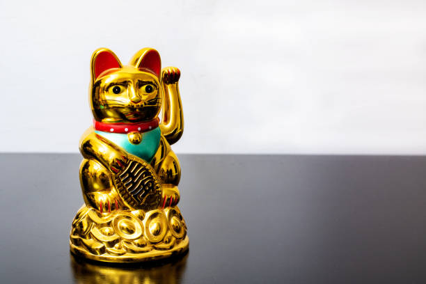 istock Japanese cat symbol with coins close up 1306081803