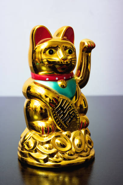 istock Japanese cat symbol with coins close up 1306081826