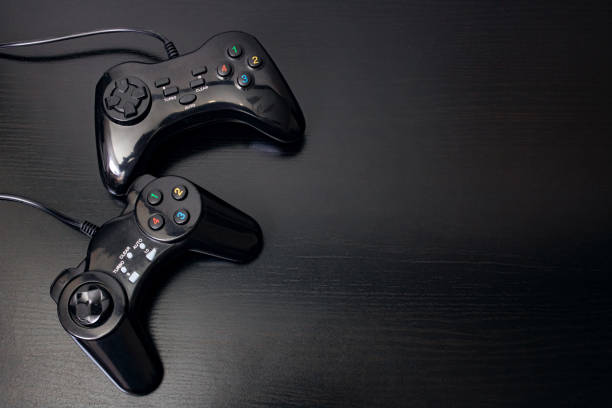 Playing joystick on a black wooden table