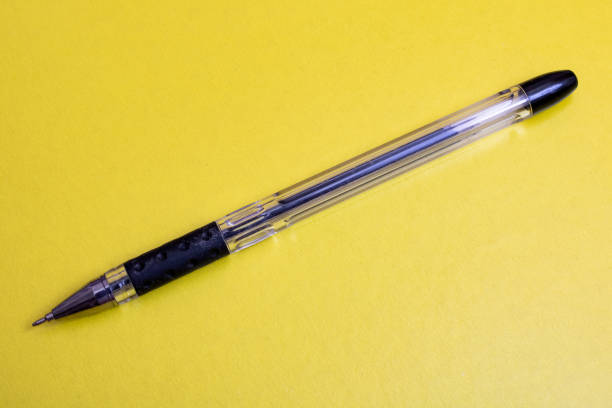 istock Black pen on a yellow background closeup 1306082119