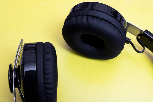 istock Black big headphones on a yellow background 1306082120