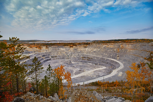 Top view of a huge crater of a stone crushed stone quarry in Russia, Chelyabinsk region, Miass city