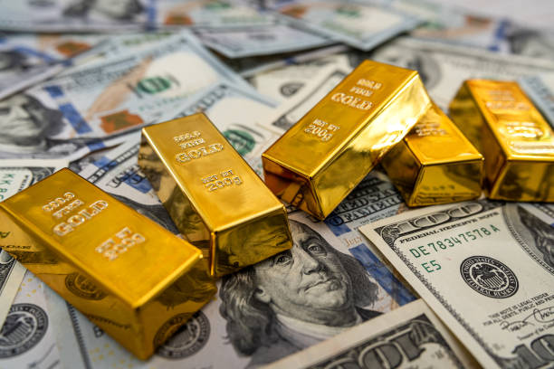 istock gold bars on American dollar bills 1306086299