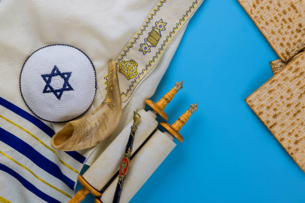istock Passover day traditional celebration with kosher matzah unleavened bread on torah scroll of Jewish holiday Pesach 1306089497