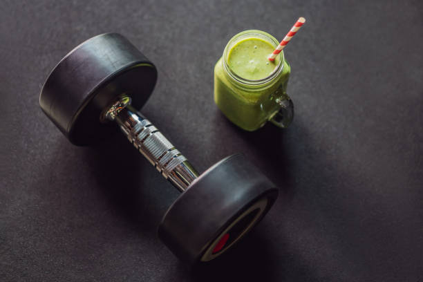 istock Green smoothies and dumbbells in the gym 1306090809