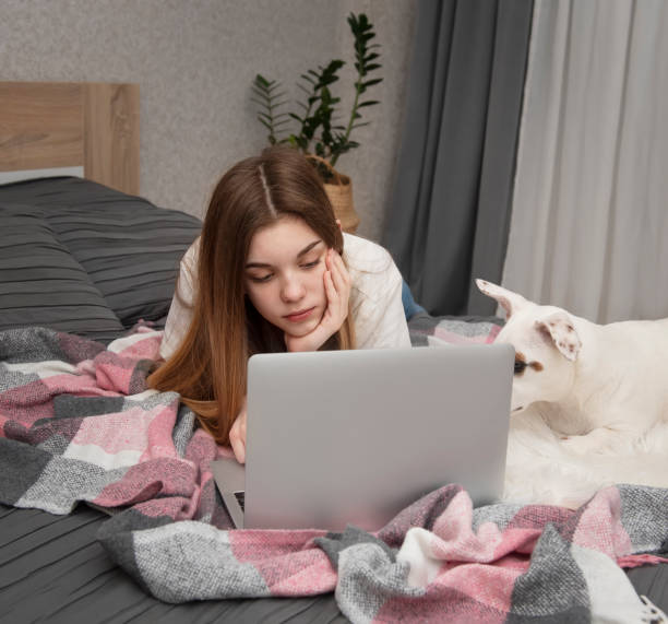 istock A young girl studies online at home. 1306091448