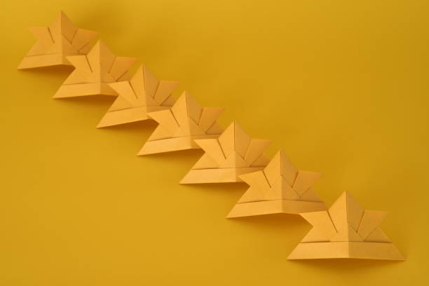 istock Origami helmet on yellow background. 1306091478