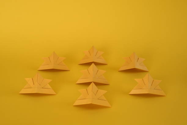 istock Origami helmet on yellow background. 1306091528