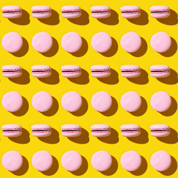 istock Seamless regular creative pattern of colorful french cookies macarons. 1306091596