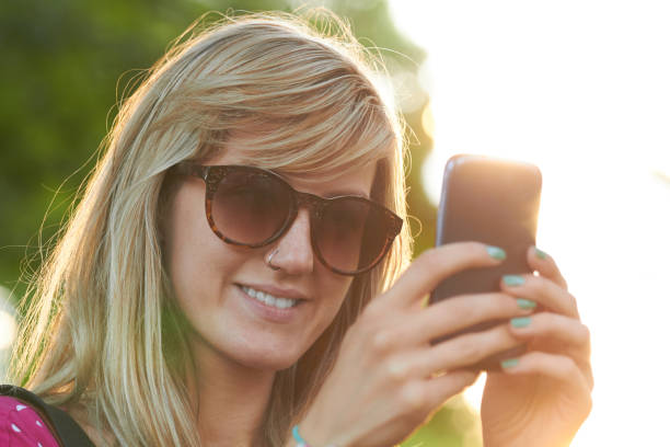 istock Young woman using modern smartphone outdoors. 1306092332