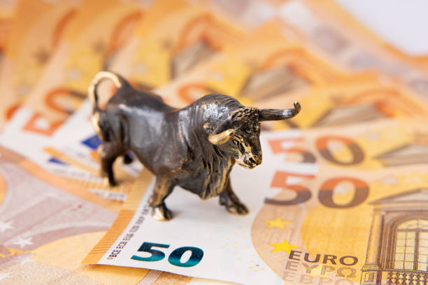 istock Bull figurine standing on euro banknotes 1306092497