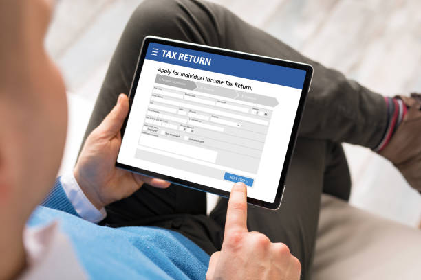 istock Man submits electronic individual income tax return form 1306092525