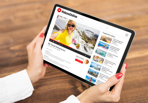 istock Woman watching videos online on tablet computer 1306092532
