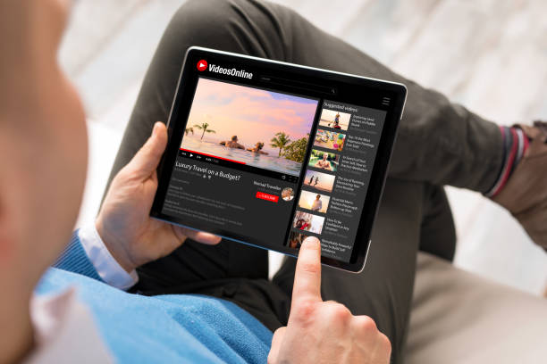 istock Man watching online videos on tablet 1306092543