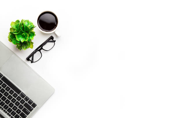istock Flat lay, top view office table desk. Workspace with, laptop,office supplies, pencil, green leaf, and coffee cup on white background. 1306097548