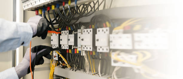 istock Electrical engineers test electrical installations and wiring on protective relays, measuring them with a multimeter. 1306097553