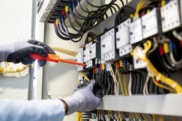 istock Electricians work to connect electric wires in the system, switchboard, electrical system in Control cabinet. 1306097586