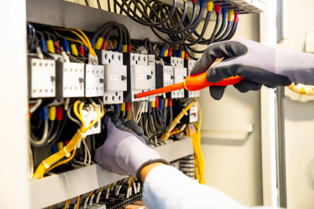 istock Electricians work to connect electric wires in the system, switchboard, electrical system in Control cabinet. 1306097606