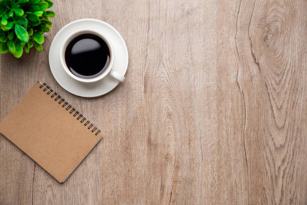 istock Flat lay, top view office table desk. Workspace with, laptop,office supplies, pencil, green leaf, and coffee cup on wood background. 1306097620