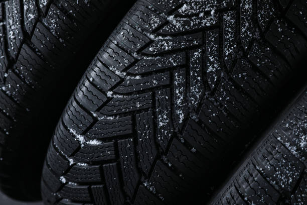 istock Snowy new winter tires as background, closeup 1306098662