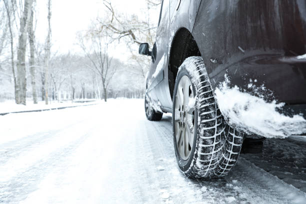 istock Modern car with winter tires on snowy road 1306098683