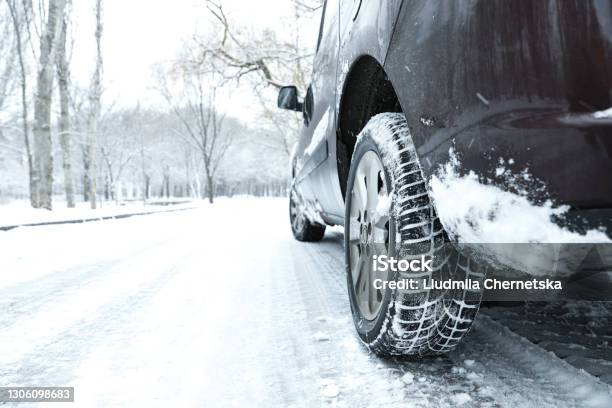 Modern Car With Winter Tires On Snowy Road Stock Photo - Download Image Now - Winter, Car, Tire - Vehicle Part