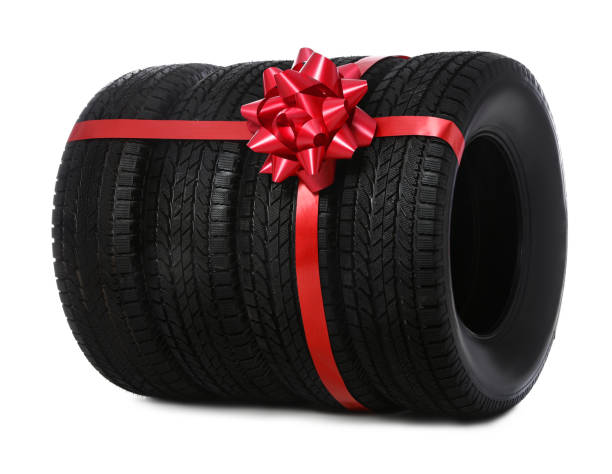 istock Winter tires with red ribbon on white background 1306099049