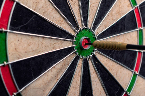 istock Side view of darts board and arrow hitting bullseye. 1306099226