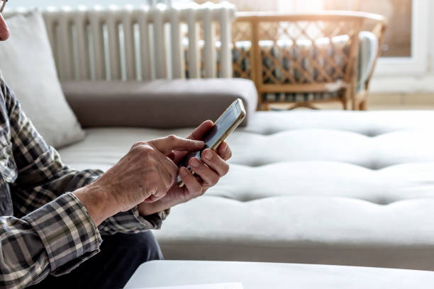 istock Shot of a old man using a mobile at home. 1306100099