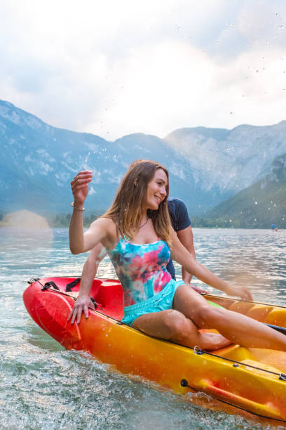 istock Cheerful active couple having fun with kayak on the lake 1306100357