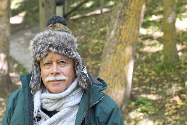 istock Senior man in the forest with warm clothing 1306104013