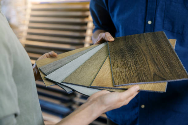 seller showing wooden texture laminate material samples to customer