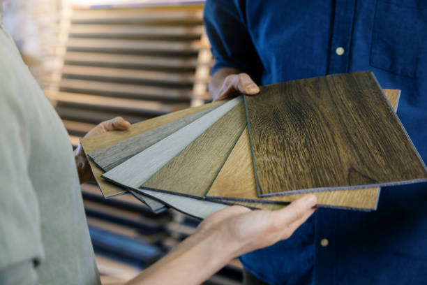 seller showing wooden texture laminate material samples to customer seller showing wooden texture laminate material samples to customer flooring stock pictures, royalty-free photos & images