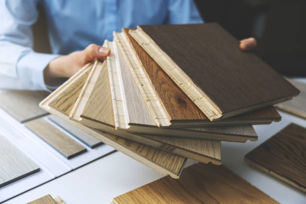 istock parquet floor - store salesman with flooring samples in hands 1306105233