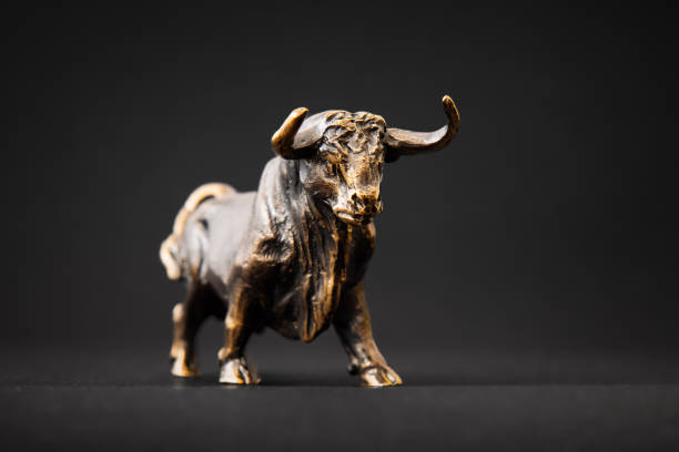 istock Bull figurine isolated on black background 1306105914