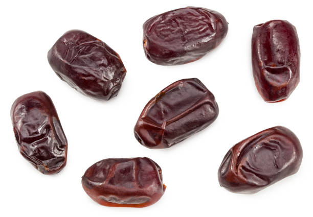 istock date fruits isolated on white background. clipping path. top view 1306107859