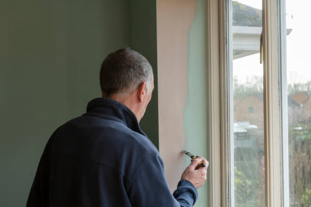 istock Senior man painting an internal wall 1306108700