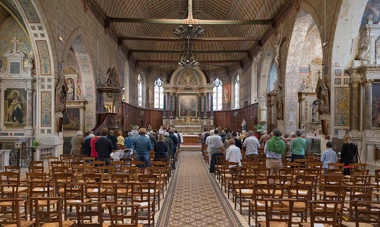 Bellême, Orne, Normandy, France, july 19th, 2015, people attending a service in the monumental  Roman Catholic Church of Saint-Sauveur in Bellême - the building is originally from the 15th century, but it was rebuilt between 1675 and 1710