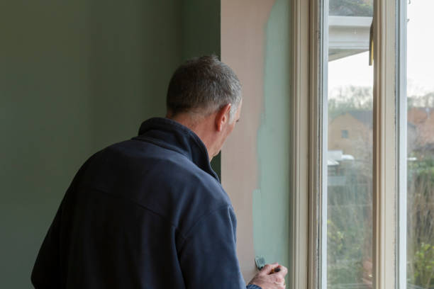 istock Senior man painting an internal wall 1306109008