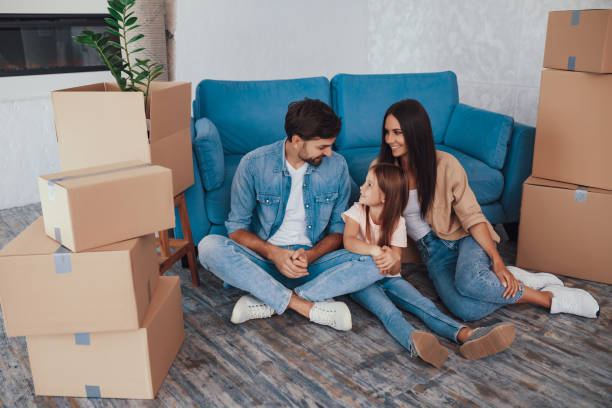 istock Excited young family posing between boxes in new appartment 1306112576