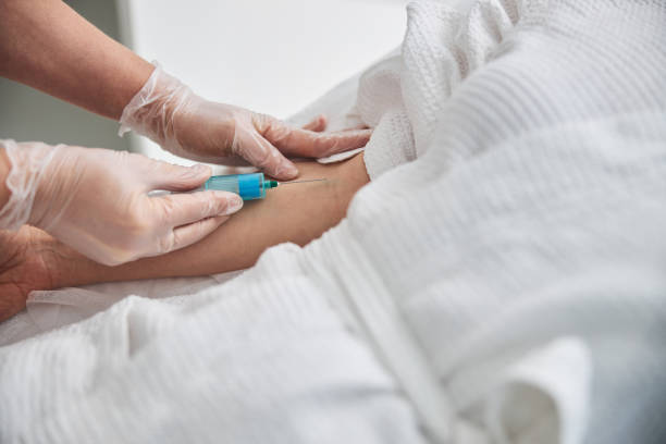 istock Female doctor making injection in patient arm 1306113905