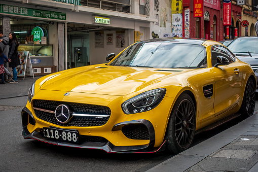 Melbourne, Australia - May 12, 2019: Yellow Mercedes Benz AMG GT-R coupe luxury sport car parked along Little Bourke Street (Chinatown). In the Central Business District (CBD) area.