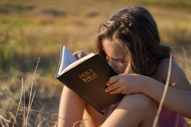 istock Christian girl holds bible in her hands. 1306114633