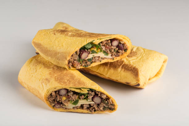 istock Tortilla roll with beef beans and fresh herbs on a white background, isolated. 1306115690