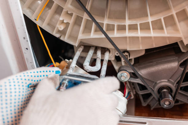 istock A worker takes out the broken heating element of the washing machine. Hands and spare part close-up. Repair 1306116742