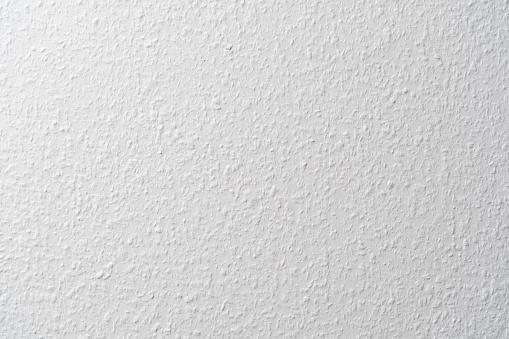 Ingrain wallpaper in white used in a German apartment on a wall. Blank white texture indoors mit a pattern caused by little wood chips to give it a structure.