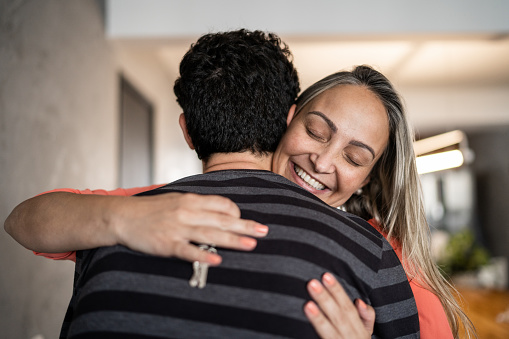 Couple embracing and holding house key